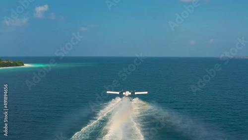 Aerail view on Seaplane taking off in a tropical island in Maldives. photo