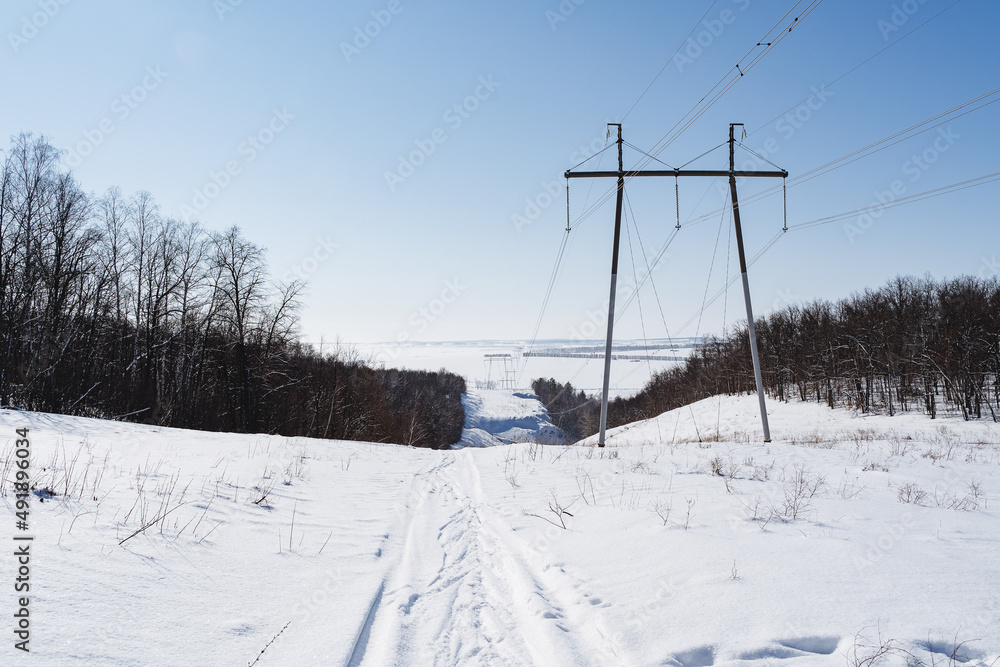 Electric transmission line. The wires of the high-voltage tower stand in the winter forest. Electric transmission line. The wires of the high-voltage tower stand in the winter forest.