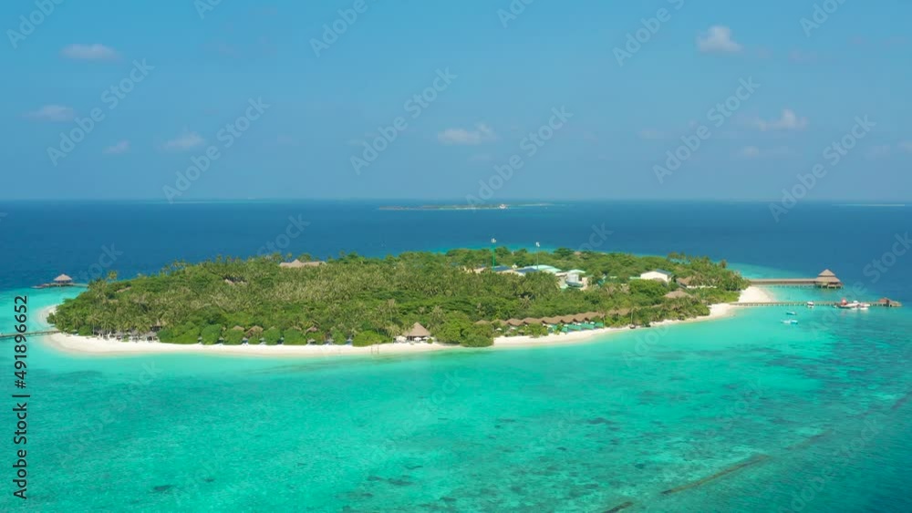 Aerial view of a tropical island and corral reef in the Indian Ocean. Aerial view of a tropical island and corral reef in the Indian Ocean.