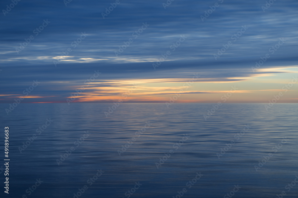 Meditation ocean and sky background. Colorful horizon over the water. Water surface. Abstract cloudscape over the sea, sunrise shot
