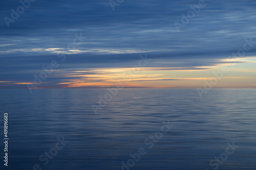 Meditation ocean and sky background. Colorful horizon over the water. Water surface. Abstract cloudscape over the sea, sunrise shot © Zelma