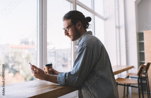 Caucasian businessman work at windowsill in office