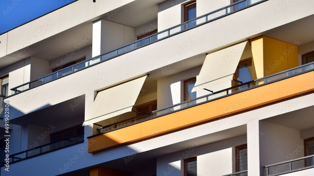 Modern architecture building facade with awnings. Balcony with awning opened, covered by sun-shield. Modern architecture building facade with awnings. Balcony with awning opened, covered by sun-shield.