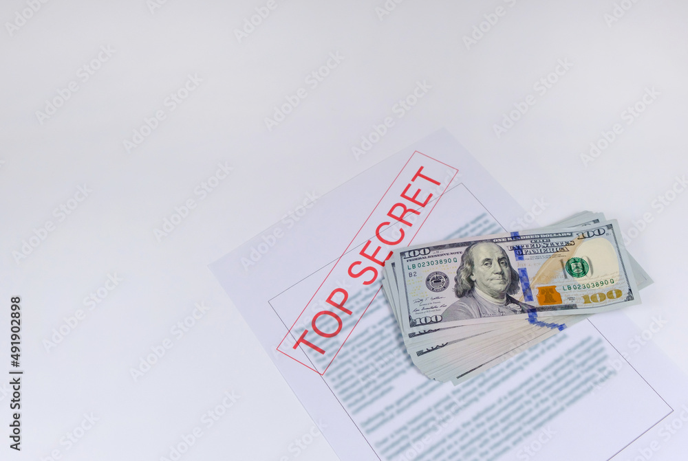 Secret documents and money on white background. Bribery and corruption concepts
