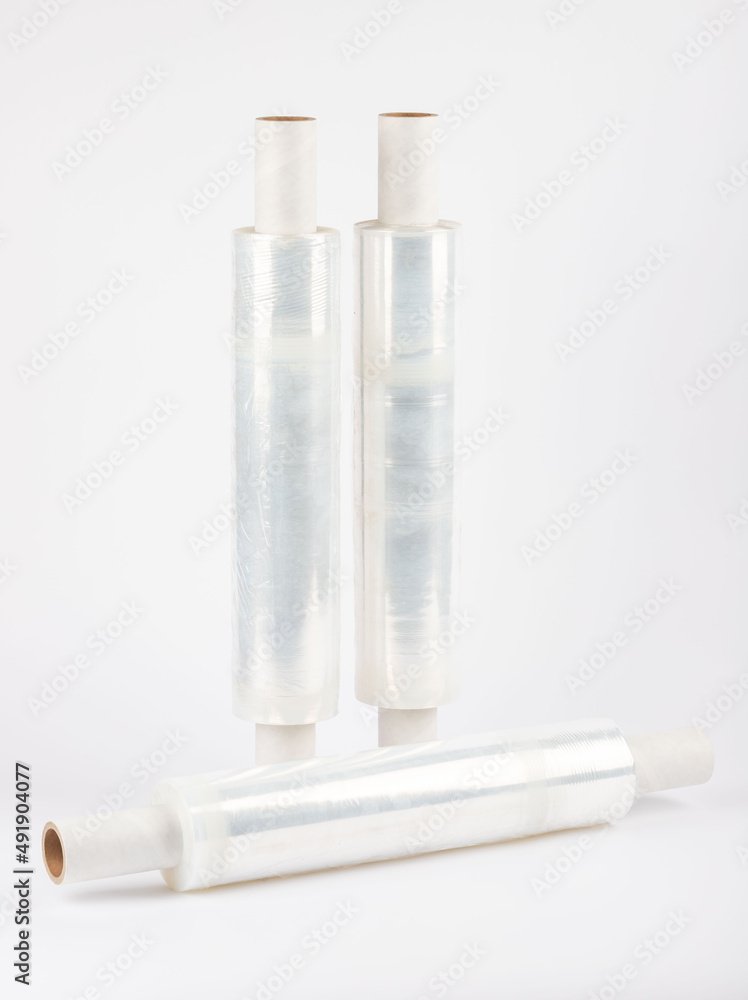Roll of plastic stretch film with clear wrap. how long the roll of cling film can stretch is shown. It stands in an isolated environment. It is used in the packaging of products. Roll of plastic stretch film with clear wrap. how long the roll of cling film can stretch is shown. It stands in an isolated environment. It is used in the packaging of products.