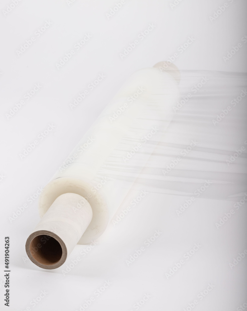 Roll of plastic stretch film with clear wrap. how long the roll of cling film can stretch is shown. It stands in an isolated environment. It is used in the packaging of products. Roll of plastic stretch film with clear wrap. how long the roll of cling film can stretch is shown. It stands in an isolated environment. It is used in the packaging of products.