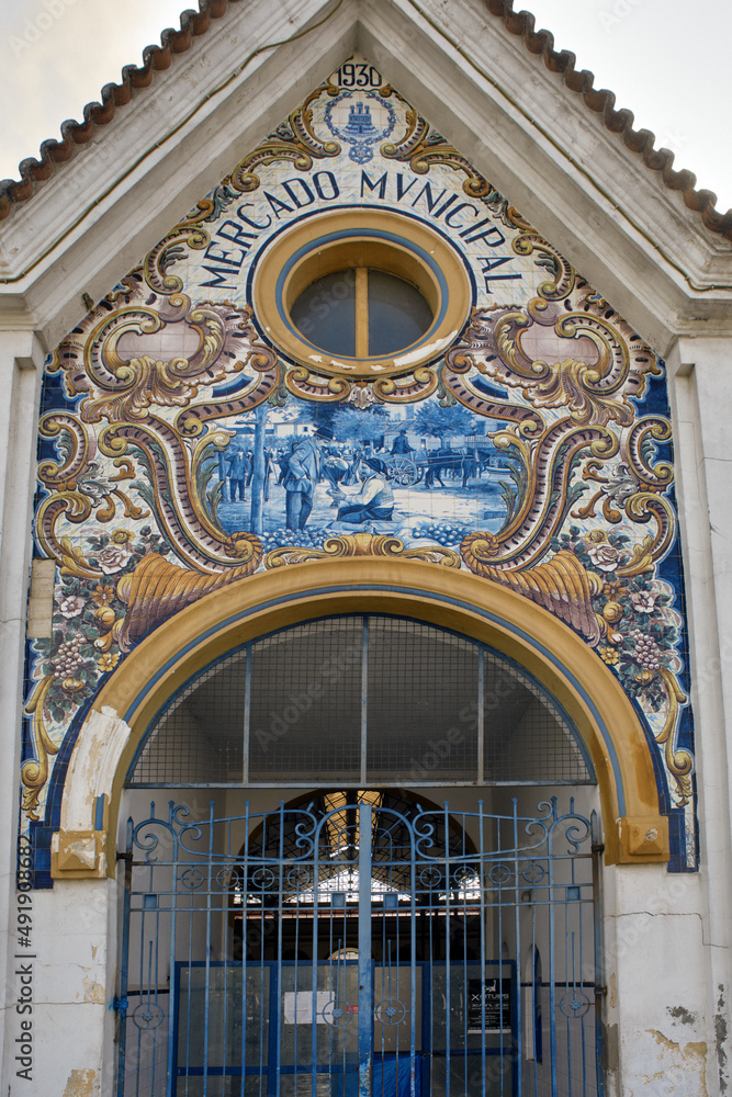 Fototapeta premium Typical Portuguese Azulejos or Blue tiles with traditional rural scenes, on the facade of Mercado Municipal of Santarem, Portugal