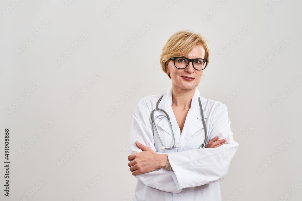 Female doctor with crossed arms looking at camera Female doctor with crossed arms looking at camera