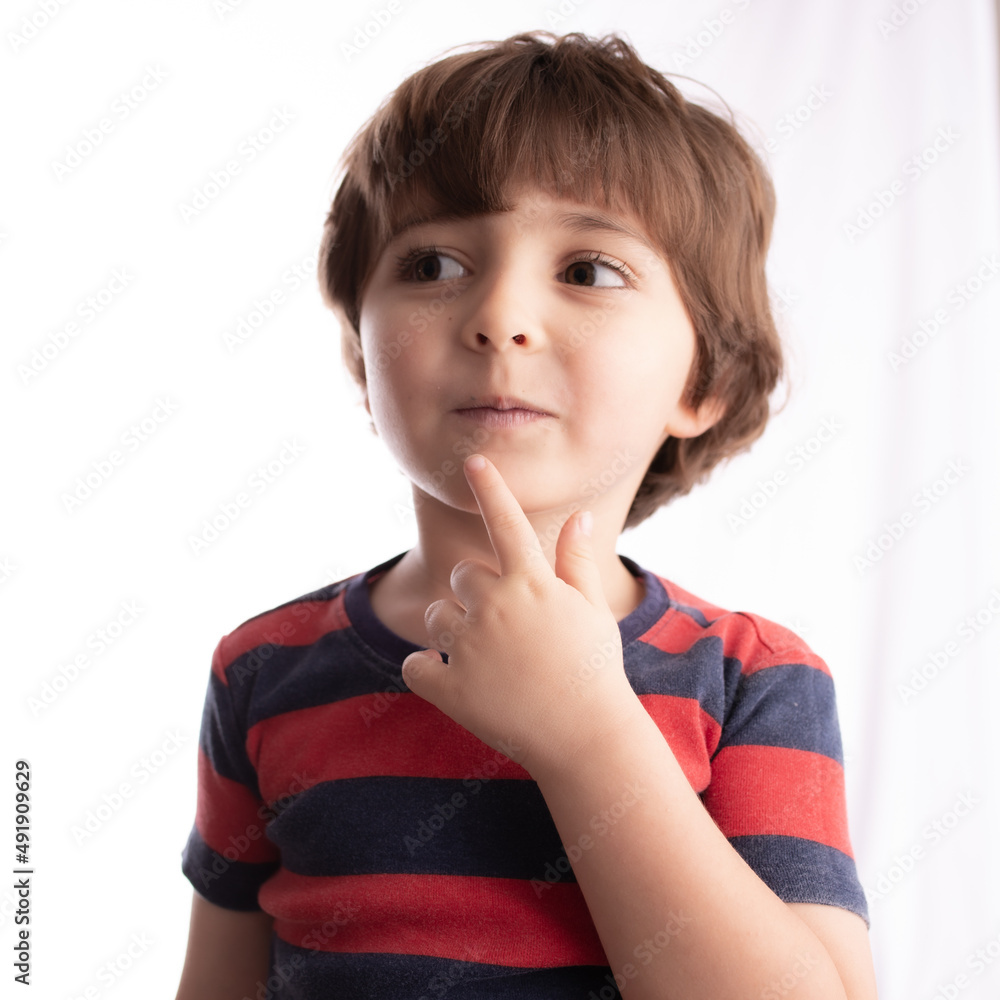 Fototapeta premium little boy making funny expressions and posing with many faces and thinking 