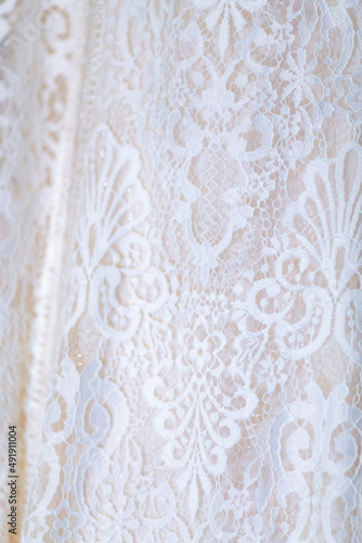 Close up view white flowers pattern on white wedding dress. Classic wedding dress styles concept