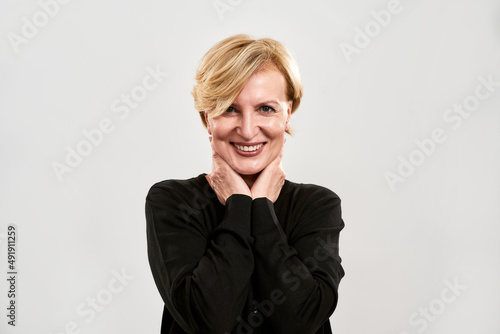 Front view of smiling adult woman look at camera