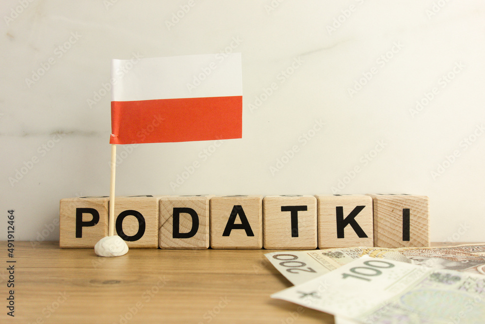 Φωτογραφία Text podatki which means taxes in Polish with flag of Poland and Zloty banknotes