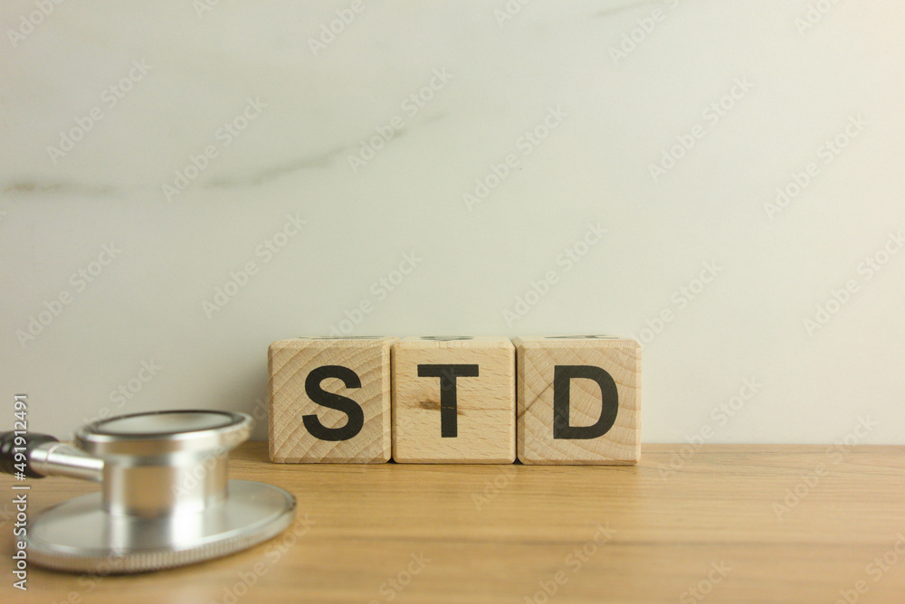 STD - Sexually Transmitted Diseases acronym from wooden blocks with stethoscope STD - Sexually Transmitted Diseases acronym from wooden blocks with stethoscope