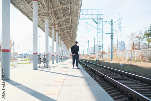 single lonely man standing on the train station and waiting for the next train trip © Mihail