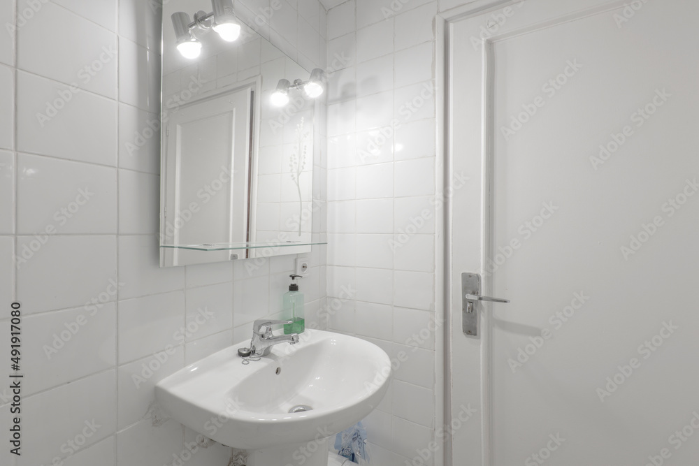 Toilet with glass shower stall, white porcelain sink in vacation rental apartment