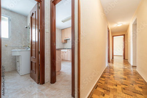 Distributor of a residential apartment with access to a bathroom  a kitchen and a long corridor leading to other rooms