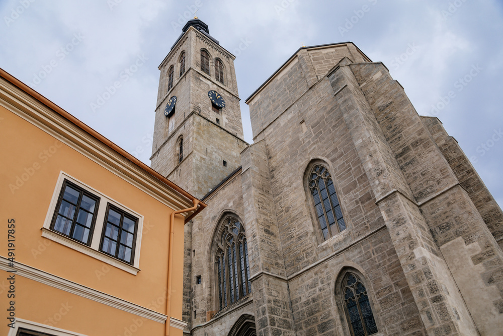 Kutna Hora, Central Bohemian, Czech Republic, 5 March 2022: Gothic stone Church of St. James or Kostel sv. Jakuba with bell and clock tower, medieval architecture at old town, lancet windows