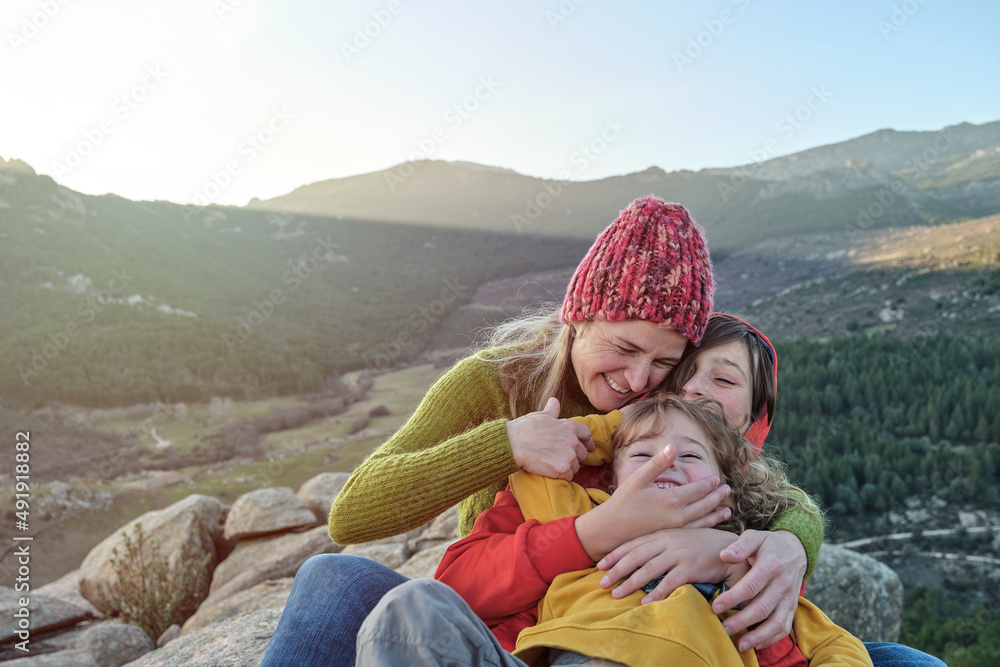 A Mother and children play and hug in nature A Mother and children play and hug in nature