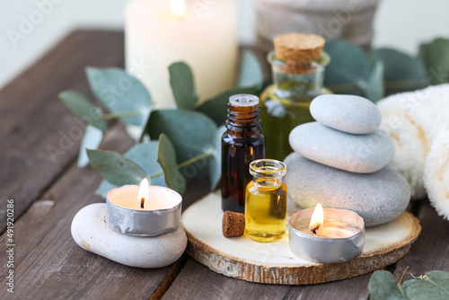 Assortment of natural oils in glass bottles on wooden background. Concept of pure organic ingredients in cosmetology. Bath accessories, atmosphere of harmony, relax. Close up macro. Healthy lifestyle