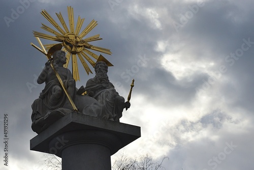 Statue of the Holy Trinity from year 1820, located near Basilica of Virgin Mary of Seven Grievances of Sastin Straze, western Slovakia.  Spring cloudy skies in background. photo