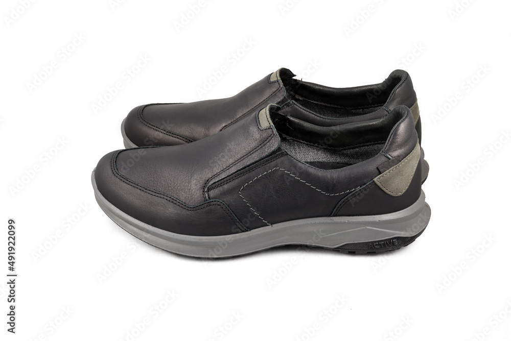 Black leather shoes isolated on white background. Full depth of field. Close-up. Black leather shoes isolated on white background. Full depth of field. Close-up.