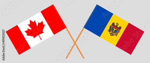 Crossed flags of Canada and Moldova. Official colors. Correct proportion