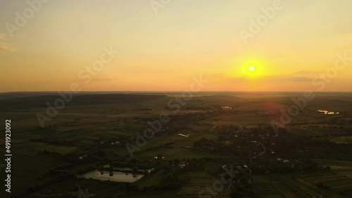 Wallpaper Mural Aerial landscape view of green cultivated agricultural fields with growing crops and distant village houses on bright summer evening Torontodigital.ca