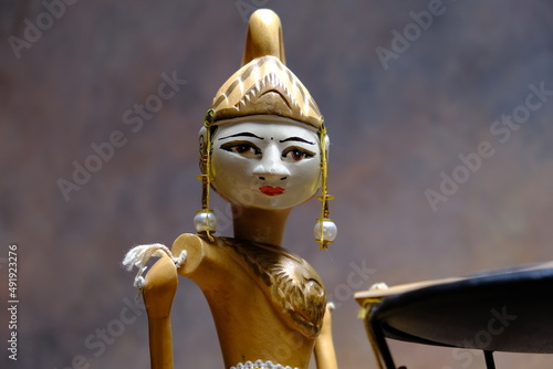 detail of an oriental statuette with typical headdress and intense expression