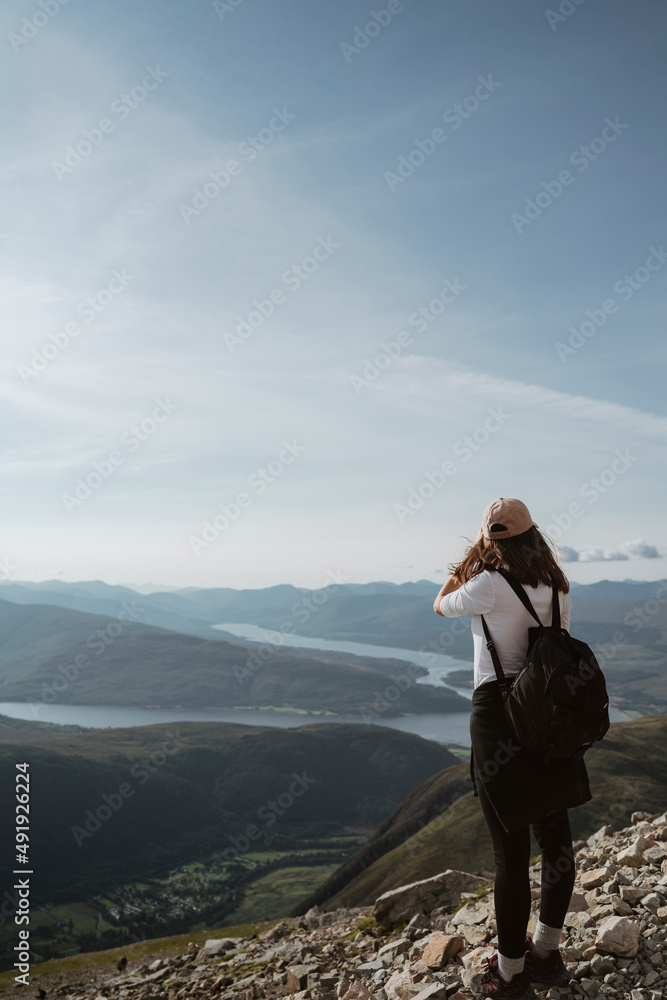 woman standing on top of the mountain Ben Nevis Scotland woman standing on top of the mountain Ben Nevis Scotland