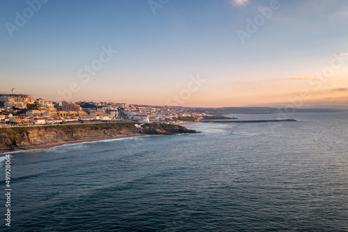 Ericeira drone aerial view on the coast of Portugal with surfers on the sea at sunset © Luis
