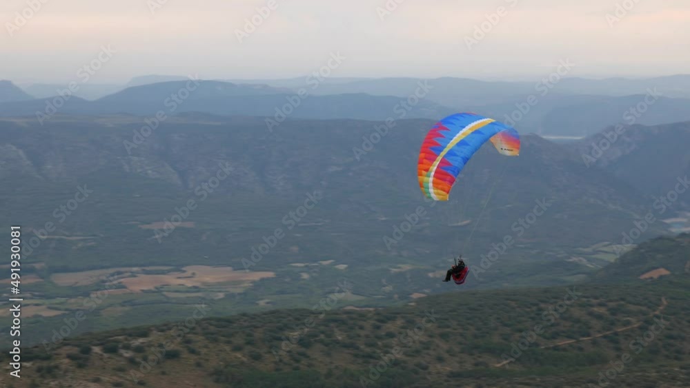 Takeoff of a woman paragliding in the mountains. Takeoff of a woman paragliding in the mountains.