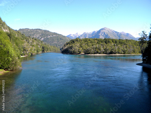 Deep blue lake, in the background the andes mountains and the argentinian patagonic forests