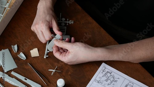 Process of the plastic model pieces buffing as a stage of model aircraft building. Model airplane assembling