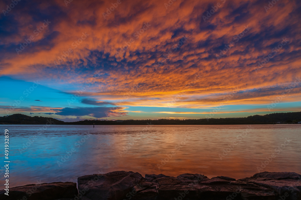 Sunrise by the bay with cumulonimbus clouds Sunrise by the bay with cumulonimbus clouds