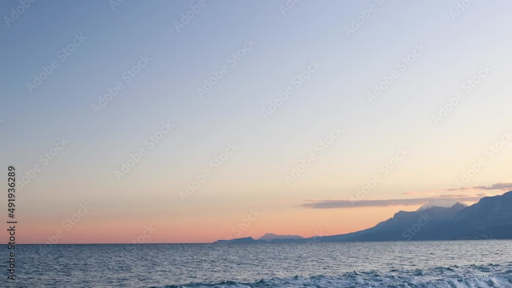 Ocean waves and a beautiful sunset sky over the horizon. mountains at sunset Ocean waves and a beautiful sunset sky over the horizon. mountains at sunset
