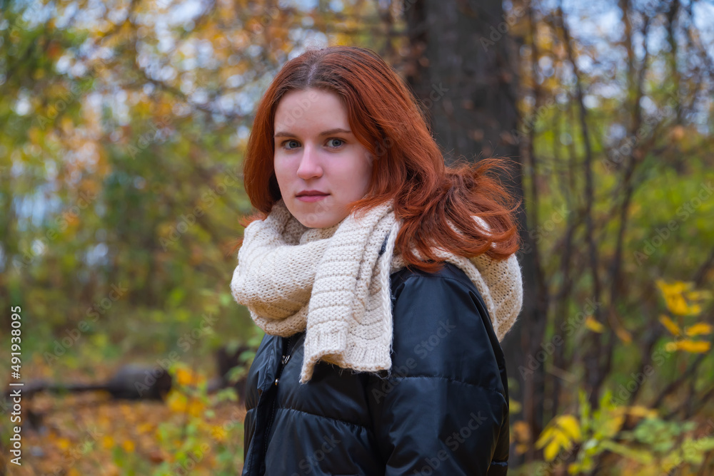 portrait of a red - haired smiling girl in a jacket smiling . against the background of autumn nature, the concept of human emotion portrait of a red - haired smiling girl in a jacket smiling . against the background of autumn nature, the concept of human emotion