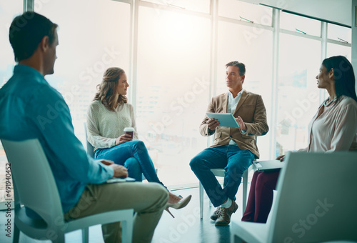 This is where everything starts for the business. Shot of a group of businesspeople taking notes while attending a meeting in the office.