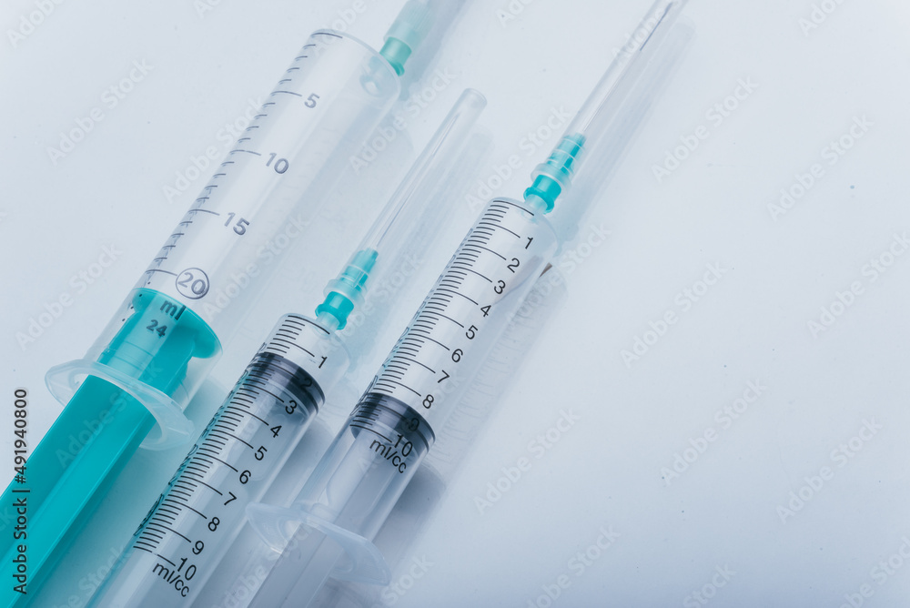 Medicine, Injection, vaccine and disposable syringe isolated, drug concept. Sterile vial medical. Medical Syringe needle. Macro close up on backgrounds gray. Medicine, Injection, vaccine and disposable syringe isolated, drug concept. Sterile vial medical. Medical Syringe needle. Macro close up on backgrounds gray.