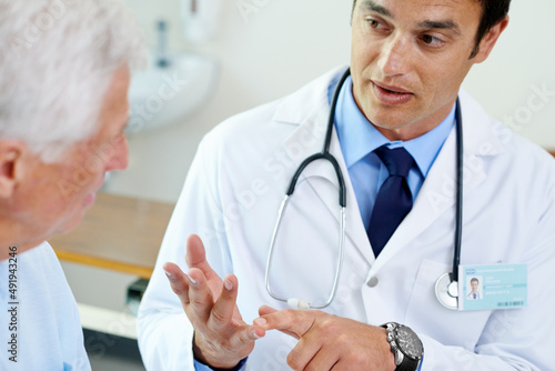 Making sure his patient understands.... Shot of a handsome young doctor explaining the situation to a senior patient.