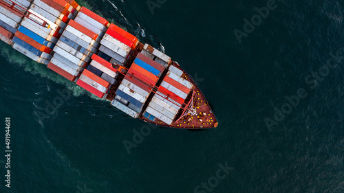 Container ship carrying container import export, Global business logistic and transportation by container ship in open sea, Aerial view container cargo vessel supply chain company freight shipping.