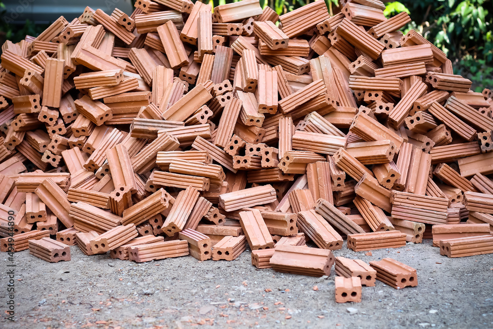 Many bricks pile on the ground construction site background