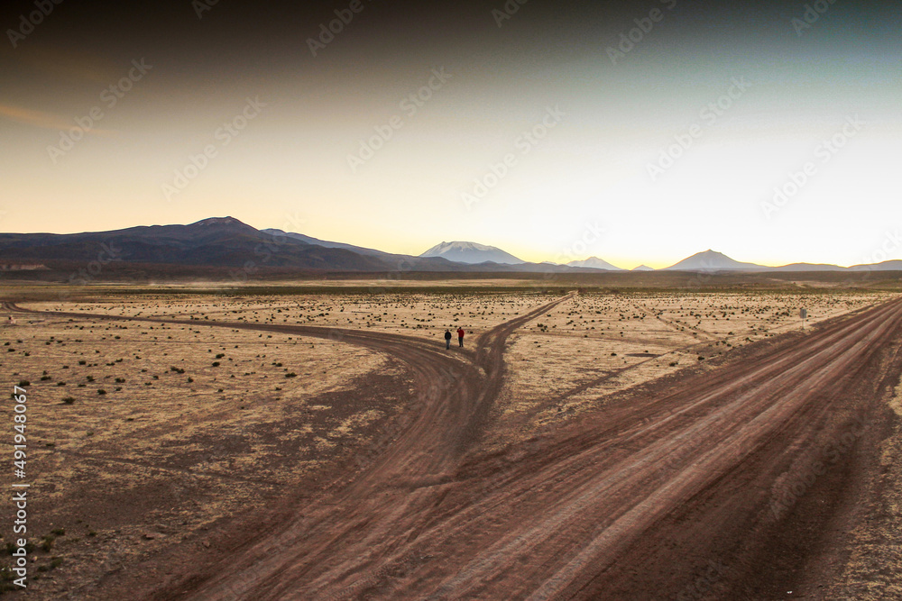 Naklejka premium Deserto do altiplano boliviano, estradas de terra e montanhas andinas no horizonte