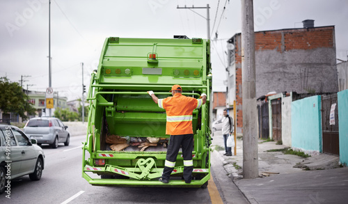 Garbage collection day. Cropped shot of a busy garbage collection worker.