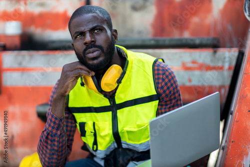 serious foreman or serious worker work at Container cargo site check up goods in container. Foreman or worker checking on shipping containers. Logistics and shipping. 