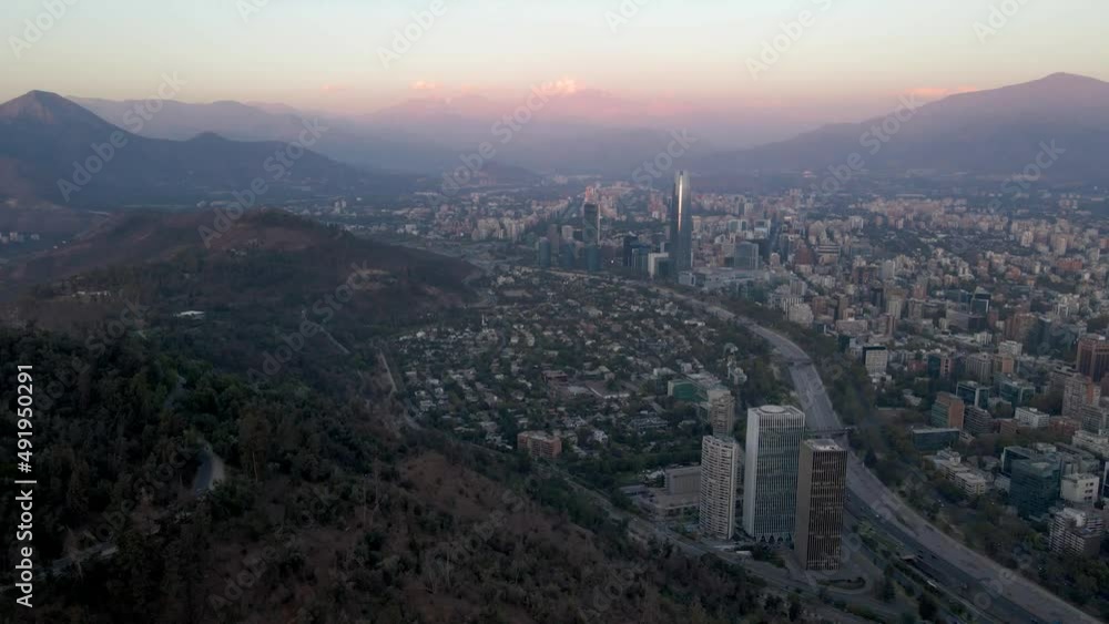 Aerial dolly in of Met Park, Santa Maria towers and Mapocho river with Santiago skyline and hills in background at sunset, Chile Aerial dolly in of Met Park, Santa Maria towers and Mapocho river with Santiago skyline and hills in background at sunset, Chile