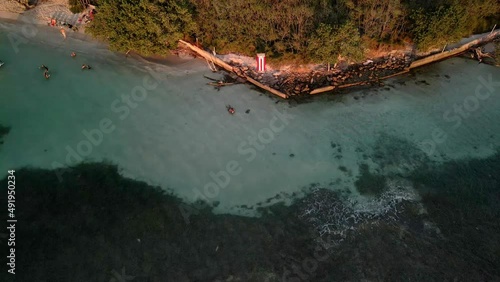 Backward Drone Puerto Rico flag video in golden hour beach. photo