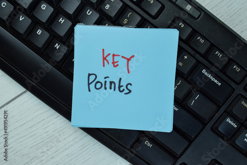 Key Points write on sticky notes isolated on Wooden Table.