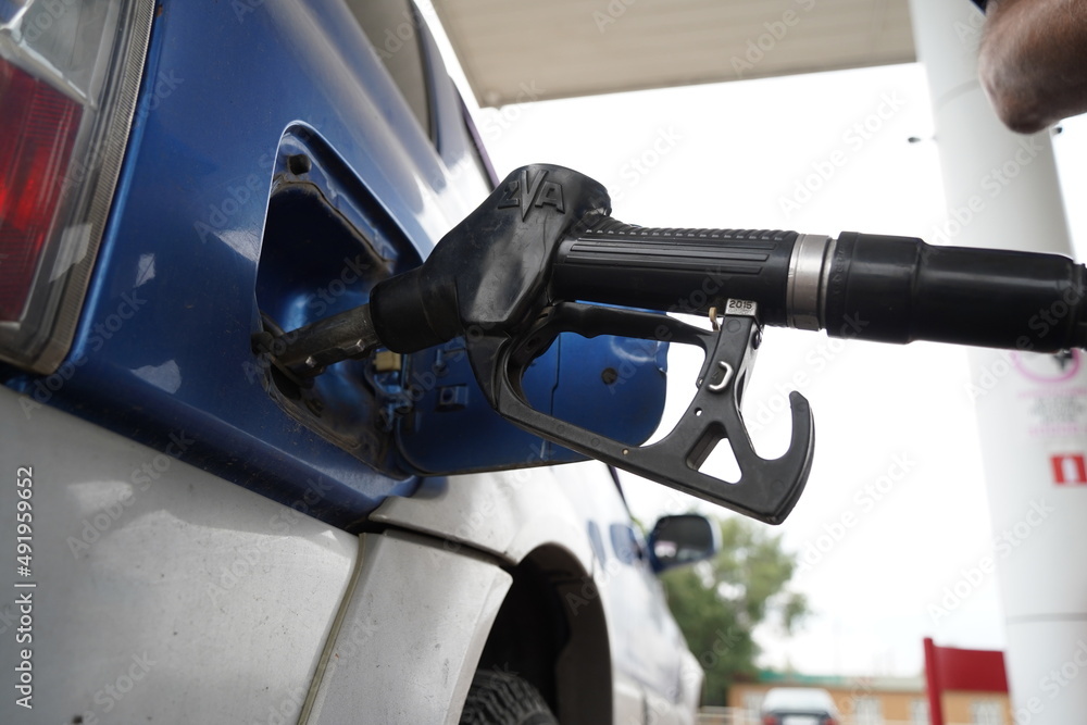 Almaty, Kazakhstan - 08.03.2021 : Fuel is poured into the tank of the car at the gas station Almaty, Kazakhstan - 08.03.2021 : Fuel is poured into the tank of the car at the gas station