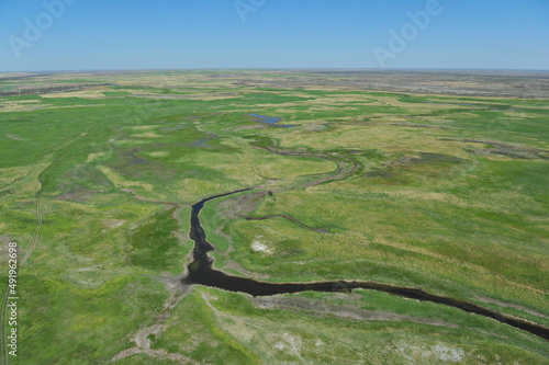 Zhambyl region, Kazakhstan - 05.17.2013 : An open valley with a riverbed and different vegetation for grazing animals photo