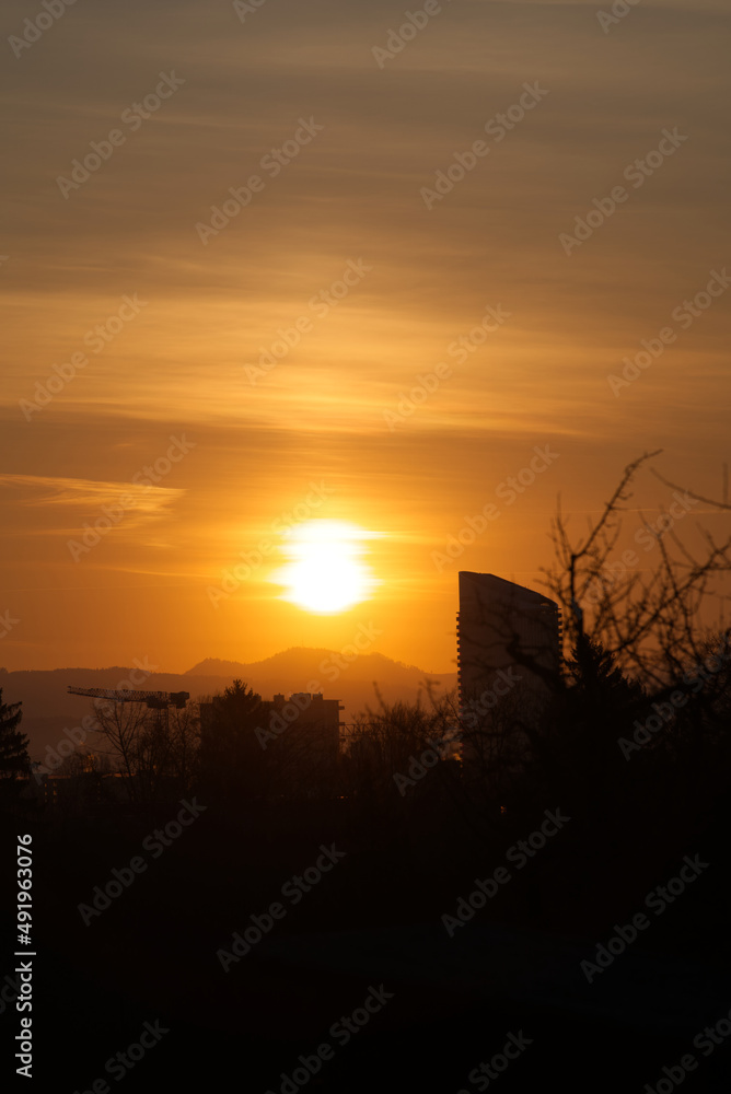 Sunrise on a beautiful spring day at Zürich Schwamendingen with crane and skyscraper in the background. Photo taken March 11th, 2022, Zurich, Switzerland. Sunrise on a beautiful spring day at Zürich Schwamendingen with crane and skyscraper in the background. Photo taken March 11th, 2022, Zurich, Switzerland.